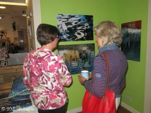 Visitor talking with Claire at Falmouth Art Gallery exhibition in 2015