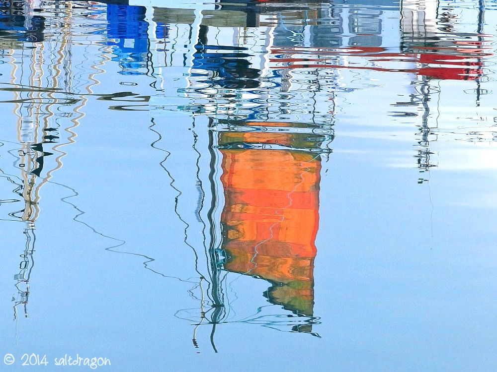 orange sail reflections at Newlyn harbour in Cornwall