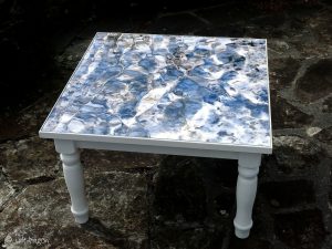 square coffee table featuring stream of light at Porth Nanven